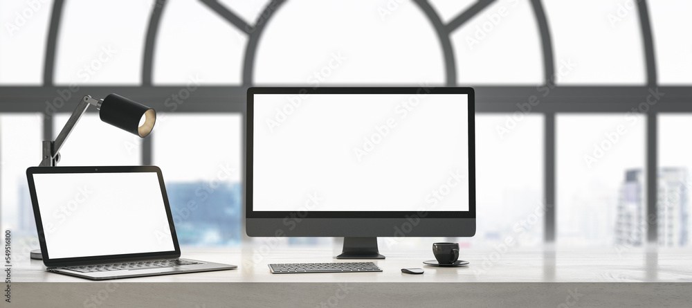 Poster close up of daylight designer table with blank white laptop computer screens, coffee cup and keyboar