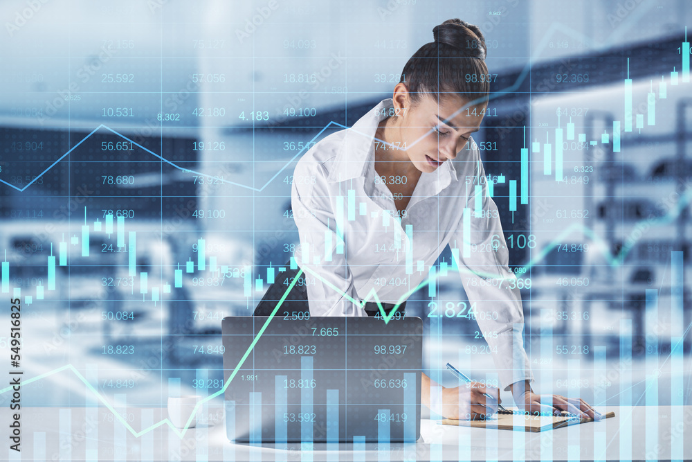 Poster businesswoman leaning and writing on desktop with glowing business chart hologram and index on blurr