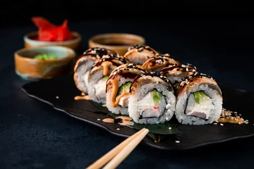 Foto op Canvas Japanese cuisine sushi rolls with smoked eel, shrimps, cream cheese, and avocado. © smspsy