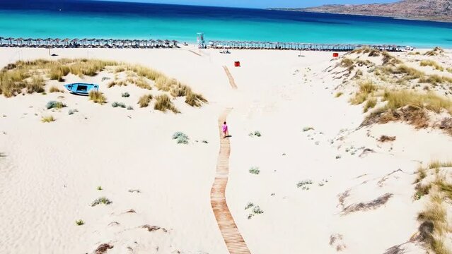 Drone aerial view: Beach Path Leading to Turquoise Crystal Clear Waters and Sandy Shores