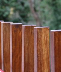 Detailed close-up and macro shot of scarecrows made of brown wood in the depths of a lush forest, mysterious, peaceful and full of oxygen. rectangular walkway railings. in autumn october november