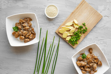 Chicken with glass noodles, cilantro and ginger on the grey concrete background, top view. 