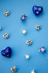 Christmas composition. A pattern of christmas balls and decorations on deep blue background. Flat lay, top view New year decor.