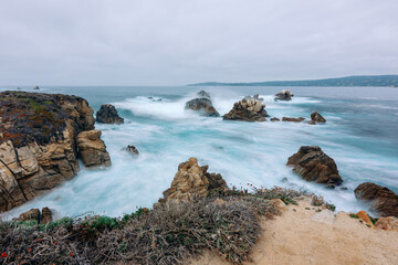 Fototapeta na wymiar Rocky beach and stormy ocean, Monterey Bay, California