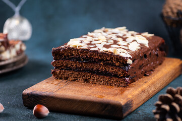 Traditional polish dessert piernik, pryanik or sponge cake with spices and honey. Rectangular piece of brown cocoa tart, gingerbread or layer biscuit. Polish christmas dessert