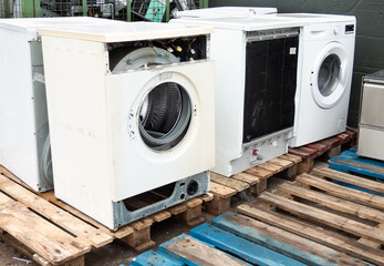 Old washing machines at a collection center for recycling. Circular economy