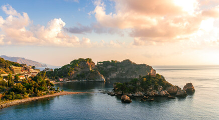 amazing view to a rocky coast and beautiful isle in sea with nice coasline and clouds on the background of the evening sea landscape