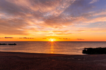 morning or evening landscape with nice beach during sunrise or sunset in sea with amazing isle with rocks and beautiful clouds on background