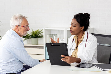 Depressed male senior adult in ambulance with afro american doctor. Doctor support and comforting her patient with sympathy