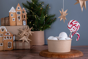 A large portion cappuccino ice cream with festive Christmas decor on a wooden table. background sparkles bokeh. New Year's desserts