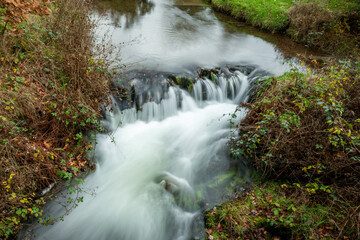 Fototapeta na wymiar Long exposure of the waterfall at Robbers Bridge in Exmoor National Park