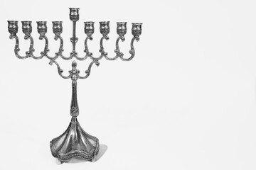 Beautiful silver hanukkah menorah. Ancient ritual candle menorah on a white background - obrazy, fototapety, plakaty