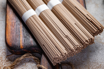 buckwheat noodles soba raw product Asian dish fresh delicious snack healthy meal food snack on the table copy space food background rustic top view keto or paleo diet veggie vegan or vegetarian food
