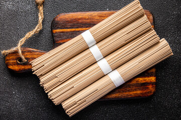 buckwheat noodles soba raw product Asian dish fresh delicious snack healthy meal food snack on the table copy space food background rustic top view keto or paleo diet veggie vegan or vegetarian food