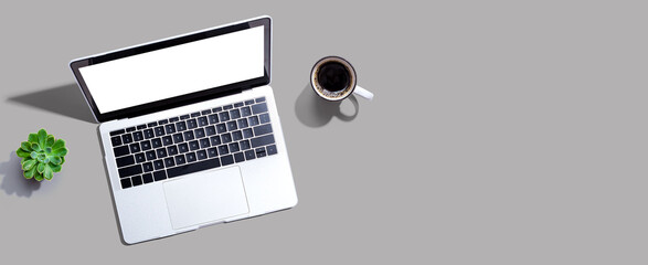 Laptop computer with a coffee cup from above