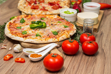 Pepperoni pizza and pizza Capricciosa with mozzarella cheese, ham, tomato sauce, salami, mushroom, pepper, spices and fresh basil