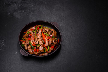 Delicious Asian teriyaki meat with red and green bell peppers