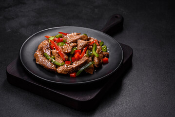 Delicious Asian teriyaki meat with red and green bell peppers