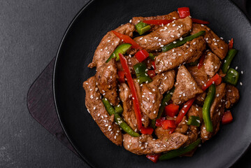 Delicious Asian teriyaki meat with red and green bell peppers