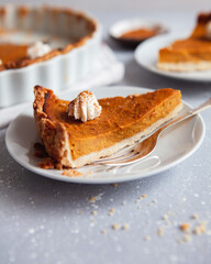 Autumn Delicious Pumpkin Pie Slice with Cream and Cinnamon Powder 