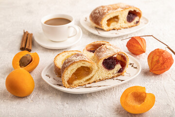 Homemade sweet bun with apricot jam on gray concrete. side view.