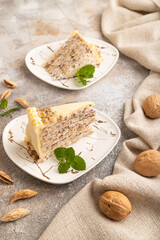 Walnut and almond cake on brown concrete, side view.