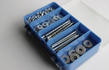 Opened Blue Set Box For Arranging Nuts, Bolts And Washers On White Surface Isolated
