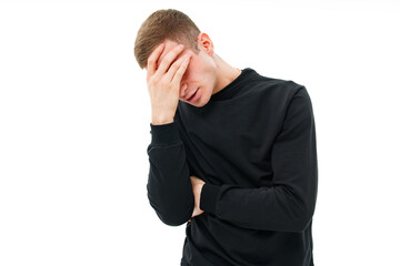 a man in black clothes holds on head on a white background.a headache or earache
