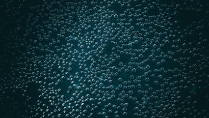 Air droplets in water on a dark background.