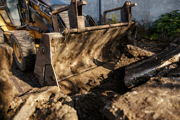 Cropped picture of excavator digging soil on construction site.