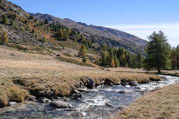 View of the scenic Valee de la Claree in the French Alps with Massif de Cerces mountains on either side of the valley, near Briancon, France