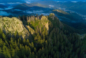 Peak of mountain range with forest in valley Rhodope mountains under sunset
