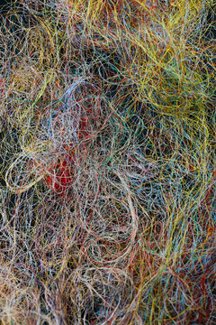 Lots of colourful threads in a mess from above view shot 