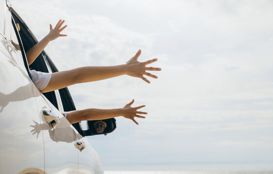 Father, Mother And Children Raise Hand Wave Goodbye, People Having Fun On Road Trip, Vacation Holiday, Happy Family Sitting In Car Waving Hands Travel Outside Car Windows Going To Beach For Travel