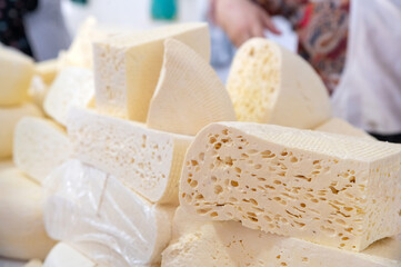Homemade Caucasian cheese or Bryndza cut in slices at local market
