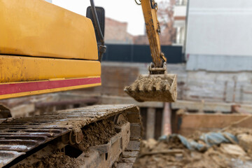 Construction excavator at work on construction site.Project in progress.