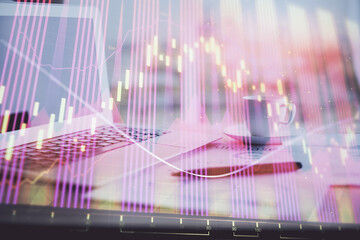 Forex graph hologram on table with computer background. Double exposure. Concept of financial markets.