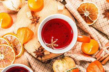 Spicy hot tea. Autumn good mood, traditional fall beverage in cups. Pumpkin, scarf, candles