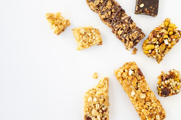 Tasty granola bars on white background, top view