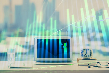 Forex graph hologram on table with computer background. Multi exposure. Concept of financial markets.