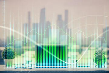 Forex graph hologram on table with computer background. Multi exposure. Concept of financial markets.