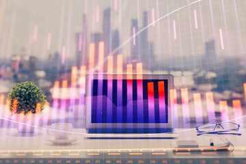 Forex Chart hologram on table with computer background. Multi exposure. Concept of financial markets.