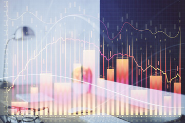 Forex graph hologram on table with computer background. Multi exposure. Concept of financial markets.