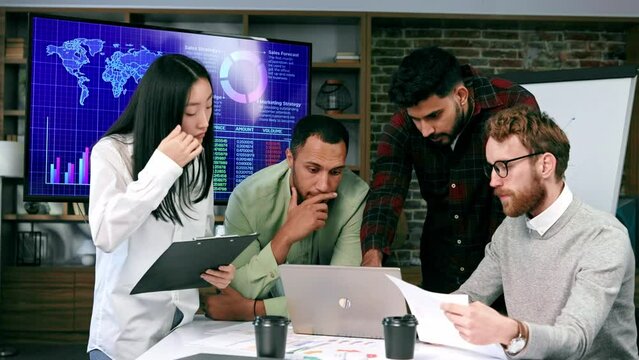 A team of young multinational business people are working on a startup. New generation of startups. communication network. Management strategy. Digital transformation. multinational professional staff