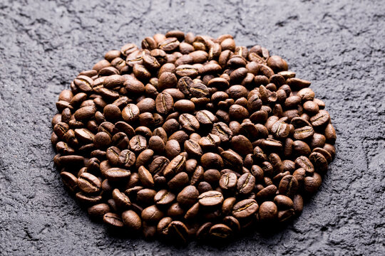 Roasted coffee beans, on dark background, closeup image, space for text