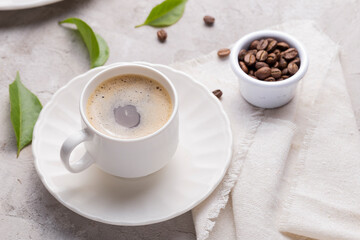 Coffee glass, roasted coffee beans on the white table