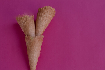 Three cones stacked. Empty ice cream cone isolated on pink background