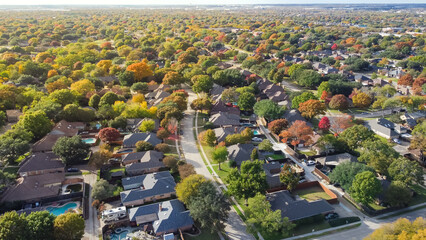 Quiet residential street situated between upscale single family homes with swimming pool and colorful fall foliage suburbs Dallas, Texas, US