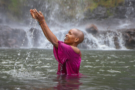Black woman playing in water