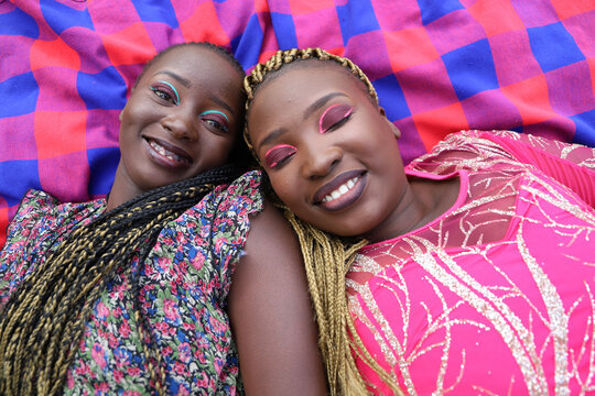 African sisters laying on a mat